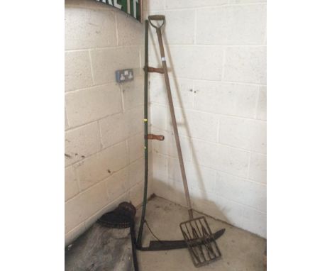 A vintage hand cultivator; and a scythe