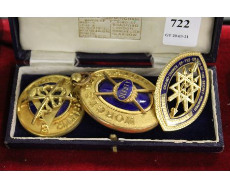Three decorative gilt and enamel badges.