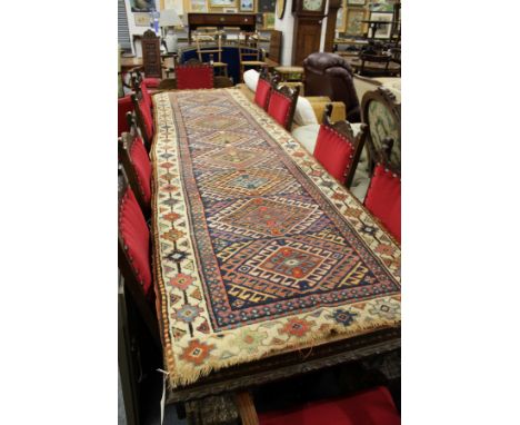 A Persian runner, blue ground with geometric lozenge shaped panels.
