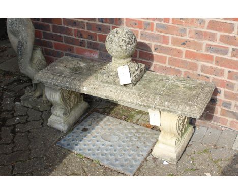 A weathered composite stone classical style bench.