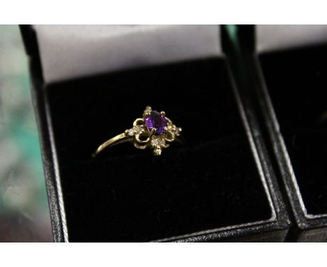 A 9ct gold and diamond and amethyst ring.