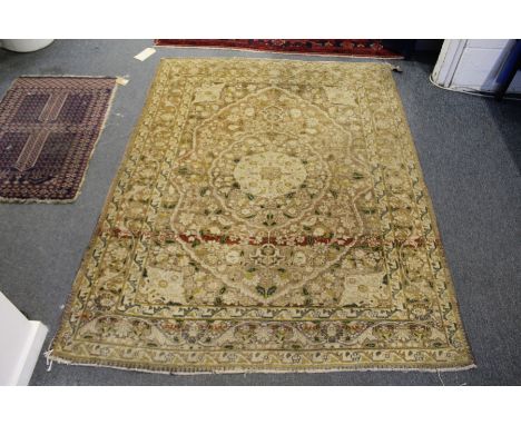 A Persian rug, light beige ground with floral decoration.