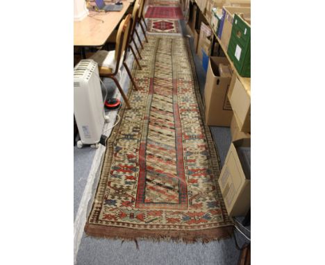 A Persian runner, beige ground with three rows of geometric design.