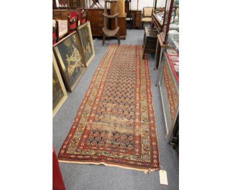 A Persian runner / hall carpet (worn).