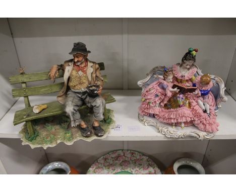 A Capodimonte tramp on a bench and a porcelain figural group.