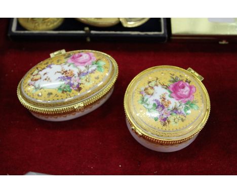 Two enamel boxes with ormolu mounted hinged covers, decorated with flowers.