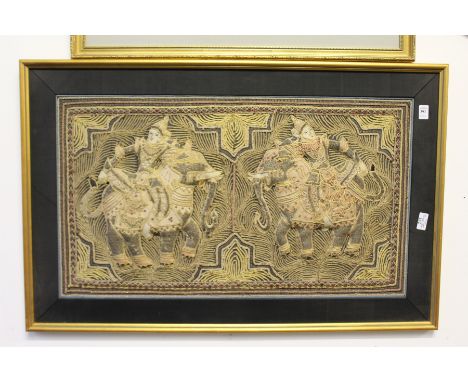 An eastern metal thread embroidered picture of two figures on elephants.