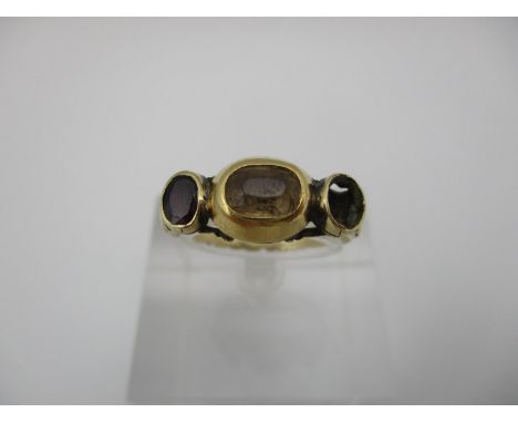 A Georgian rose cut gem set yellow metal ring, set to the centre with possible citrine, flanked with a ruby, the other missin