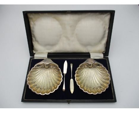 A cased pair of George V silver butter dishes by Harrison Brothers and Howson, Sheffield 1921, modelled as clam shells raised