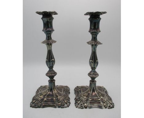 A pair of Victorian silver candlesticks by Henry Wilkinson, Sheffield 1894, designed with knapped stems, spool shaped removab