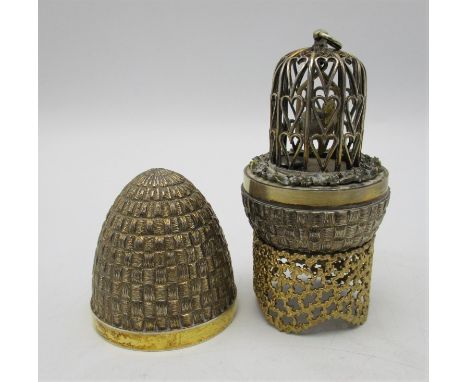 A Stuart Devlin novelty silver gilt surprise egg, London 1981, the inside revealing a pair of budgies in a cage, the egg with