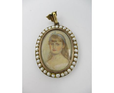 An Edwardian yellow metal oval pendant set with a portrait miniature and band of pearls and a glazed panel to the reverse, on