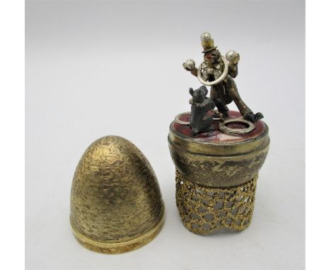 A Stuart Devlin novelty silver gilt surprise egg, London 1981, the inside revealing a circus dog and clown, with enamel work,