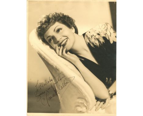 COLBERT CLAUDETTE: (1903-1996) American Actress, Academy Award winner. A good vintage signed and inscribed sepia 11 x 14 phot