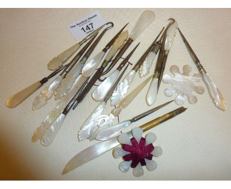 Mother of pearl handled manicure tools, button hooks, Chinese engraved thread winders, etc.