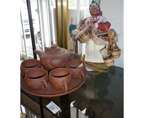 Victorian Pedlar doll with baskets and contents and a Chinese Yixing tea set on tray with teapot having Foo dog in lid