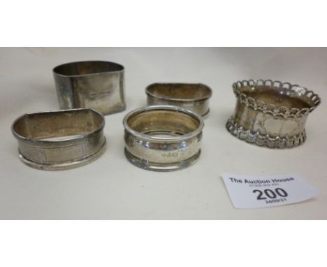 Five various silver serviette rings