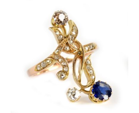 FABERGÉ; an early 20th century yellow metal diamond and sapphire 'fancy' ring, the open framework set with sapphire, white di