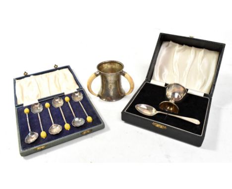 WILLIAM AITKIN; an Elizabeth II hallmarked silver christening egg cup and spoon, both initialled 'J', Birmingham 1964, a silv