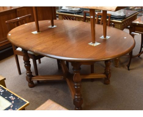 ERCOL; a 'Golden Dawn' extending oval dining table, raised on turned block legs, width 108cm.