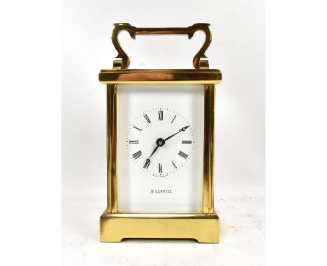 H SAMUEL; a brass cased carriage clock with eleven jewel Fema movement, the dial set with Roman numerals, height excluding sw