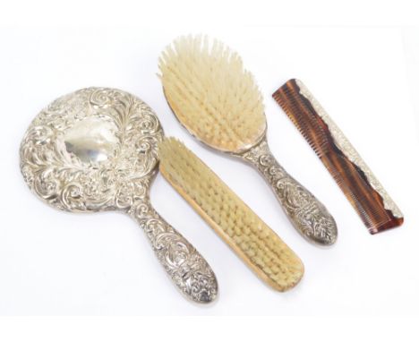 W I BROADWAY &amp; CO; a hallmarked silver three piece dressing table set comprising hand mirror, hair brush, clothes brush, 