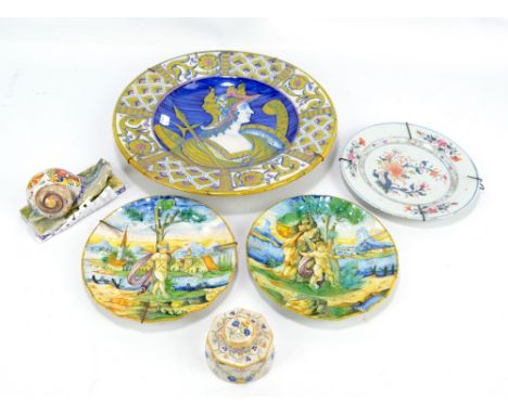 CANTAGALLI; a pair of 19th century majolica plates, each decorated with cherub in landscape and both bearing printed marks to