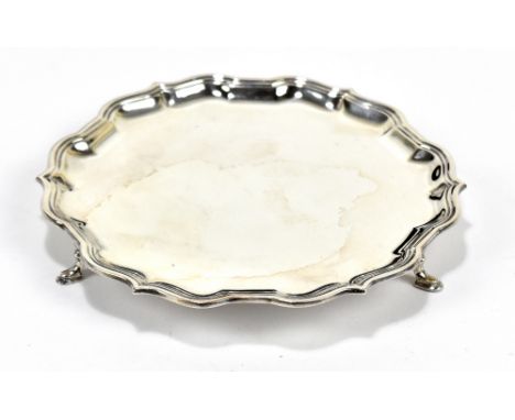 CJ VANDER LTD; an Elizabeth II hallmarked silver circular card tray of shaped outline on three pad feet, Sheffield 1966, diam