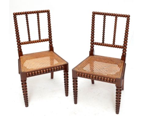 A pair of 19th century walnut bobbin turned cane seated side chairs raised on tapering front legs and of good colour.Addition