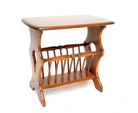 ERCOL; a 'Golden Dawn' magazine rack/occasional table with rounded rectangular top, length 55cm.