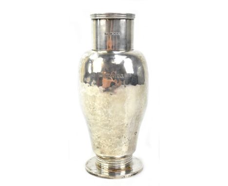 JOSIAH WILLIAMS &amp; CO; a George V hallmarked silver cocktail shaker with hammered finish to reeded base and circular foot,