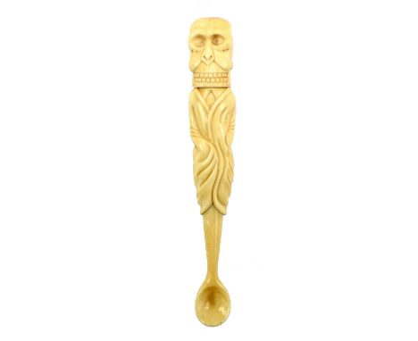 An unusual Victorian marine ivory corkscrew or pipe tool, the terminal modelled as a skull unscrewing and housing a corkscrew