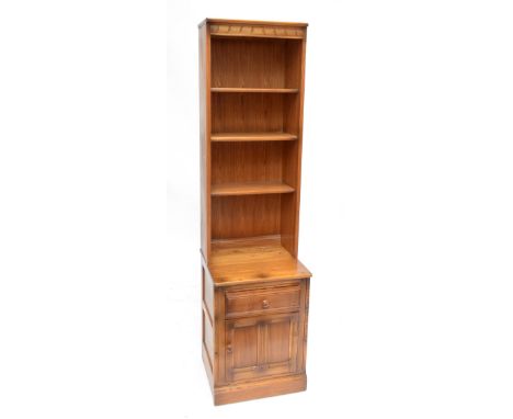 ERCOL; a 'Golden Dawn' open bookcase, the upper section with three shelves above a base with drawer and cupboard beneath, wid