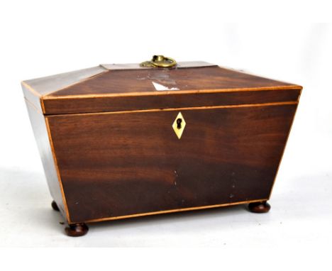 A Victorian mahogany inlaid sarcophagus tea caddy with bun feet, length 28cm.Additional InformationThere are some splits to t