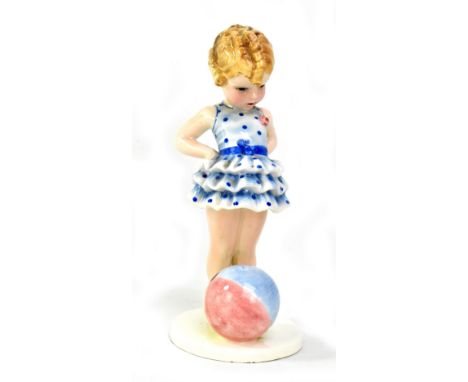 STEFAN DAKON FOR GOLDSCHEIDER; an Art Deco figurine of a girl standing beside a multi-coloured beach ball, impressed signatur