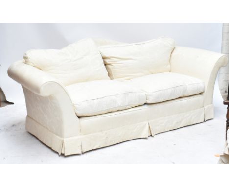 A contemporary three seater sofa, upholstered in a floral cream material, length 199cm.