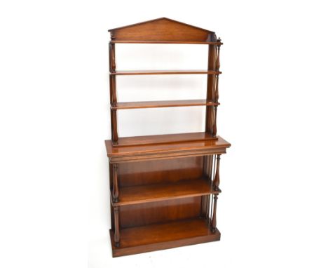 A reproduction mahogany two tier open fronted bookcase, with four fixed shelves, flanked by baluster and cylindrical columns,