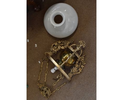 An early 20th century gilt painted hanging oil lamp, with detachable brass reservoir marked Youngs, with milk glass shade, he