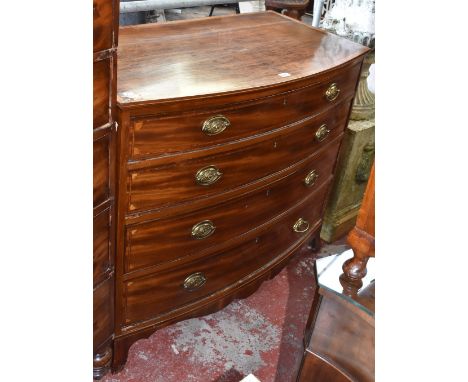 A George IV mahogany and crossbanded line inlaid bowfronted chest of four long graduated drawers raised on splayed bracket fe