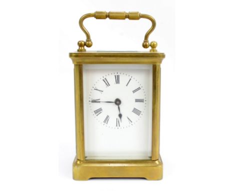 A brass cased carriage clock set with Roman numerals, height 11cm, with travel case.