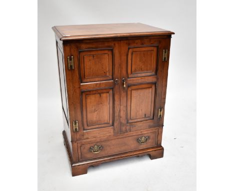 A cherrywood twin door television cabinet with single base drawer, raised on bracket supports, height 98cm, width 73cm, depth