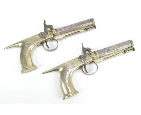 A pair of Irish all steel percussion pistols with engraved detail throughout, proof marks to the octagonal barrel, also inscr