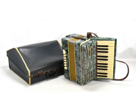 An Alvari piano accordion in mother of pearl effect case, complete with travel carrying case.