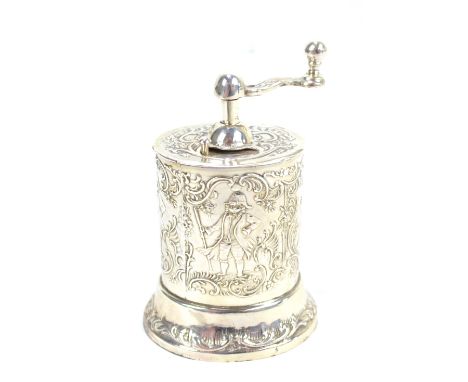 A sterling silver pepper grinder with figural decorated ovoid body and spreading oval foot, import marks, height 10cm.
