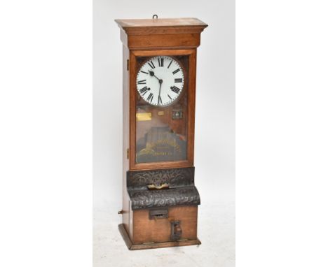 An early 20th century oak cased National Time Recorder clocking on clock, with applied brass plaque and stenciled text to gla