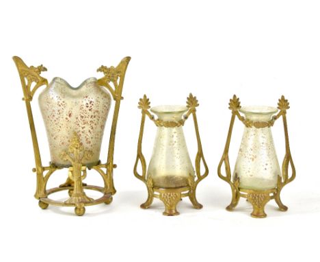 An Art Nouveau Loetz three piece garniture, each with central green glass body having speckled decoration and cast gilt mount