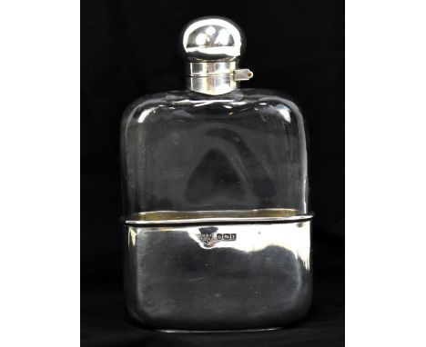 G &amp; JW HAWKSLEY; an Edward VII hallmarked silver mounted clear glass hip flask and cup, the twist-action lid bearing remn