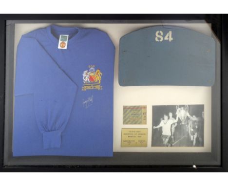 A framed and glazed display containing an original 1966 Wembley Stadium seat back numbered 84 (number 1925/2000) and a retro 