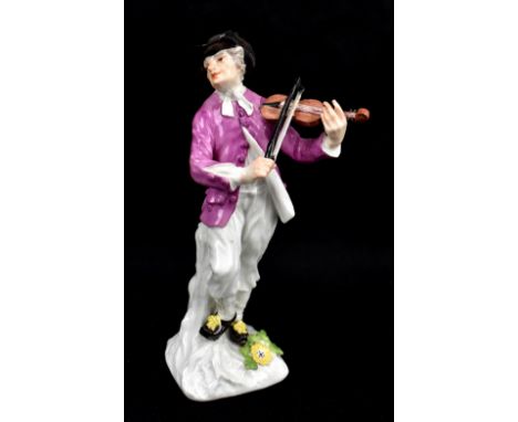 MEISSEN; a mid-18th century figure of a fiddle player, circa 1745, modelled by JF Eberlein, blue painted marks to back of bas