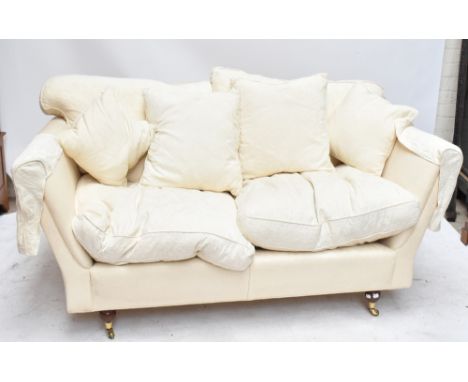 A contemporary two seater sofa upholstered in cream floral material, length 178cm.